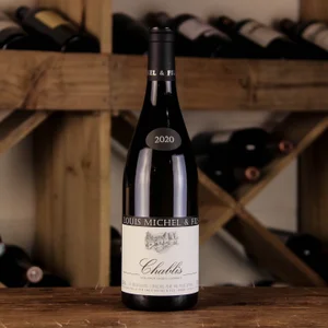 A bottle of Louis Michel Chablis in a wooden rack