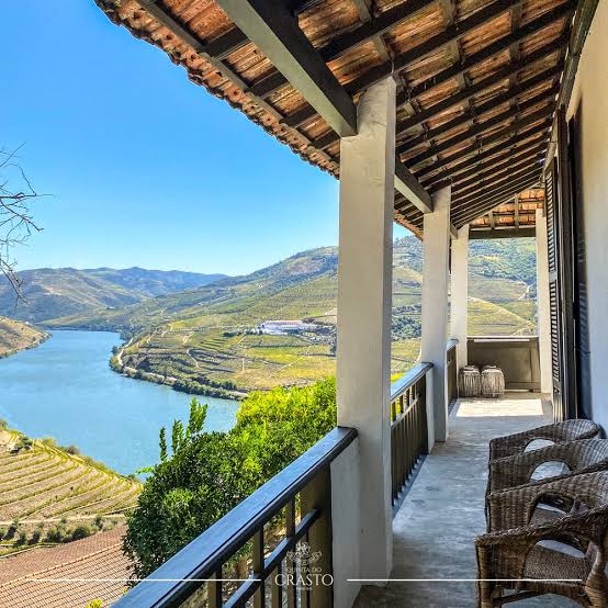 A shaded balcony looking out over the Douro and terraced vineyards