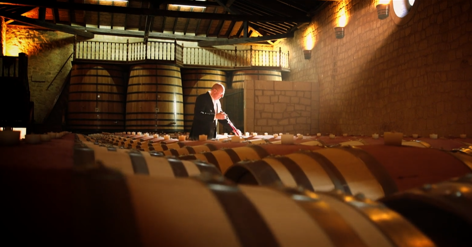 Tasting from barrel in the cellar