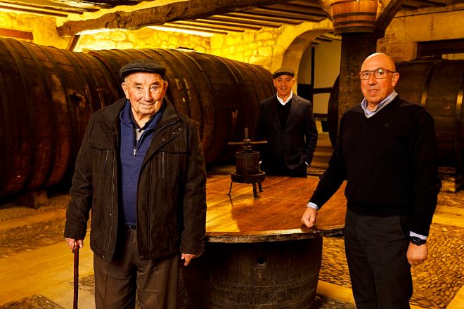 Three members of the Eguren family standing in the cellar at Sierra Cantabria