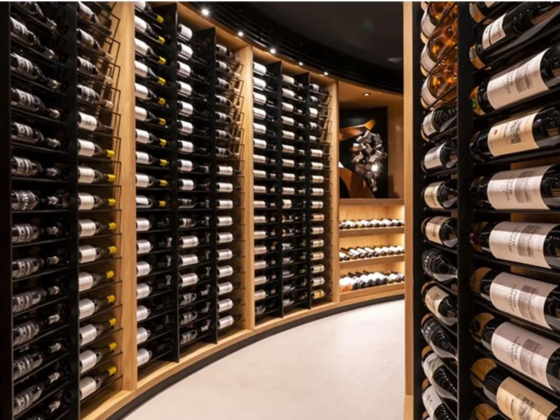 A sweeping wall of racked bottles curving through the Ambivium cellar