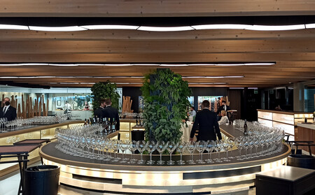 The circular tasting counter at Ambivium set with rows of glasses before service