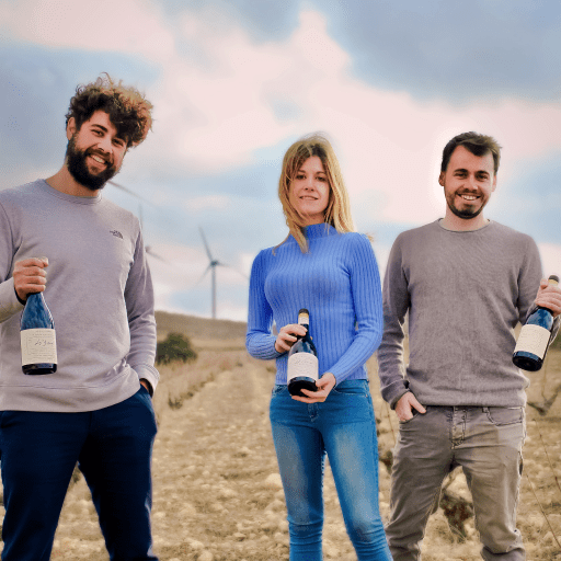 The three Cerdán siblings holding wines in the countryside