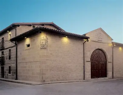 The stone façade of the Sierra Cantabria bodega at dusk