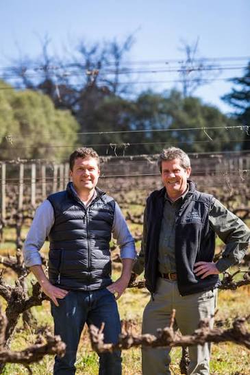 Two members of the Webb family standing in the vineyard