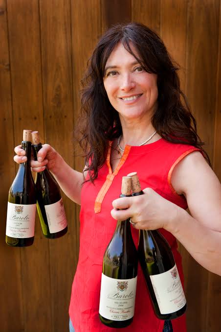 Chiara Boschis holding four bottles from E. Pira e Figli
