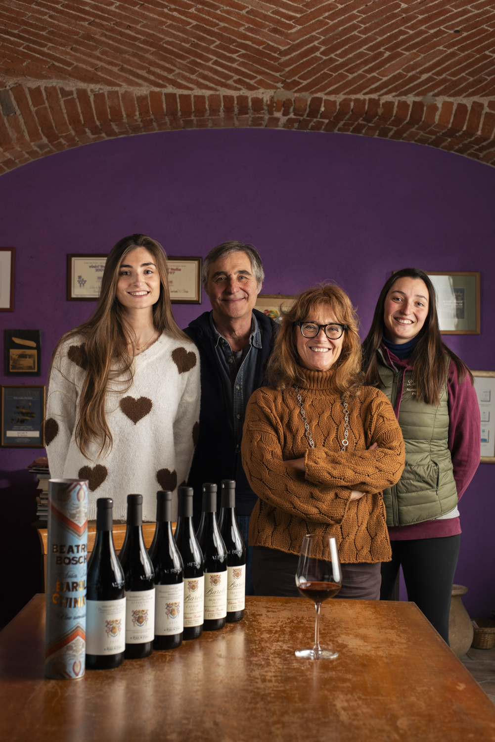Four members of the Boschis family behind a table of E. Pira e Figli wines