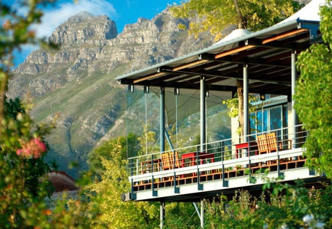 The upper deck of the tasting building with the mountain rising behind