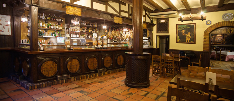 The wooden bar and tiled floor of Mesón de José María