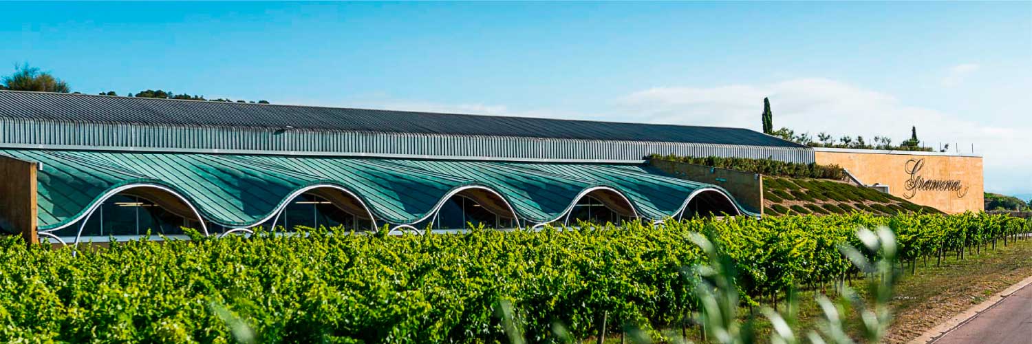 The sweeping roof of the Gramona winery surrounded by vineyards in the Penedès