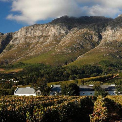Kleinood farm buildings beneath the rocky mountain slopes