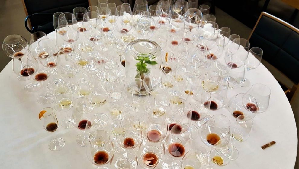 A round table covered with dozens of tasting glasses from a pairing menu